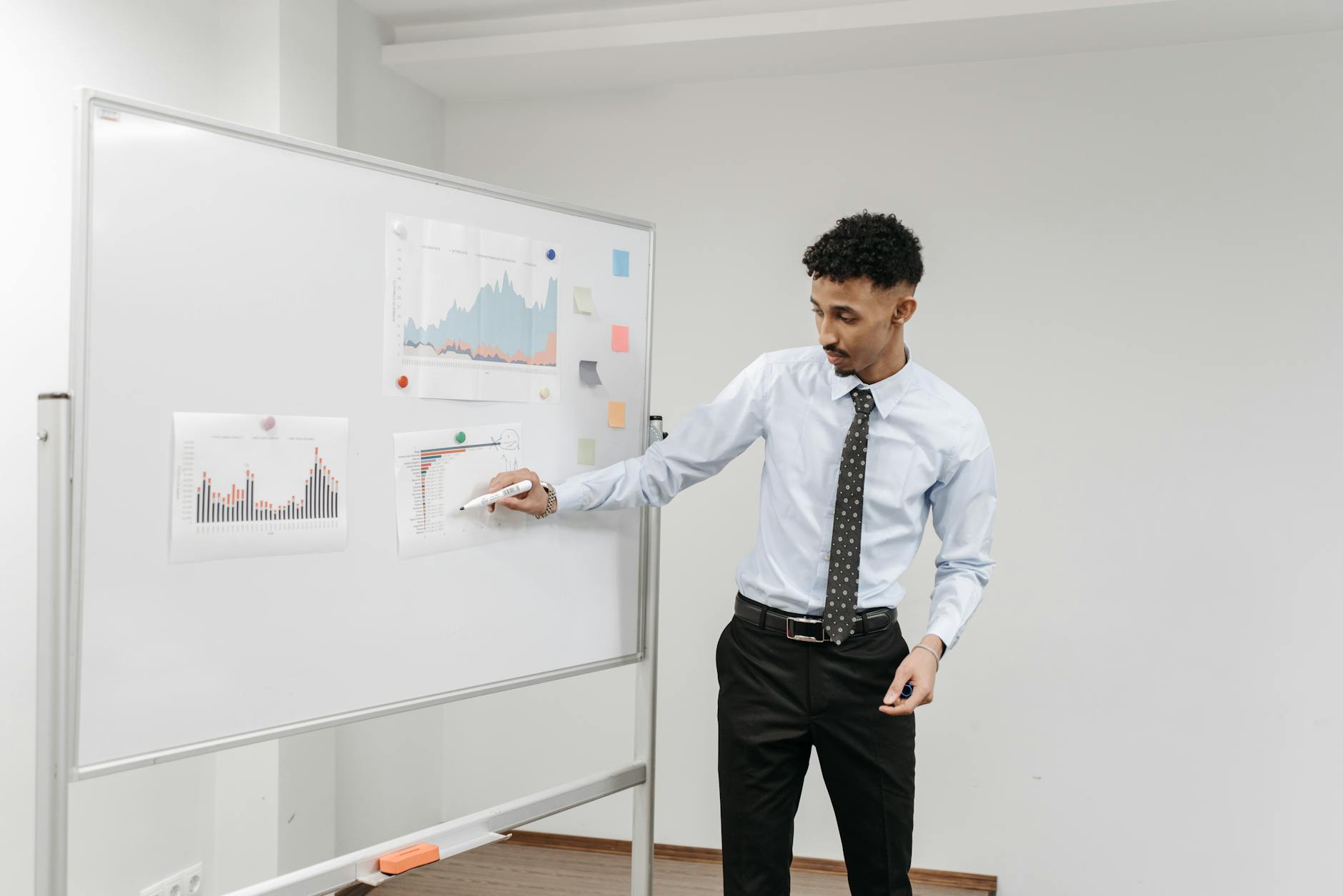 Grupp av företagare analyserar kostnadsrapporter och diagram under ett möte.